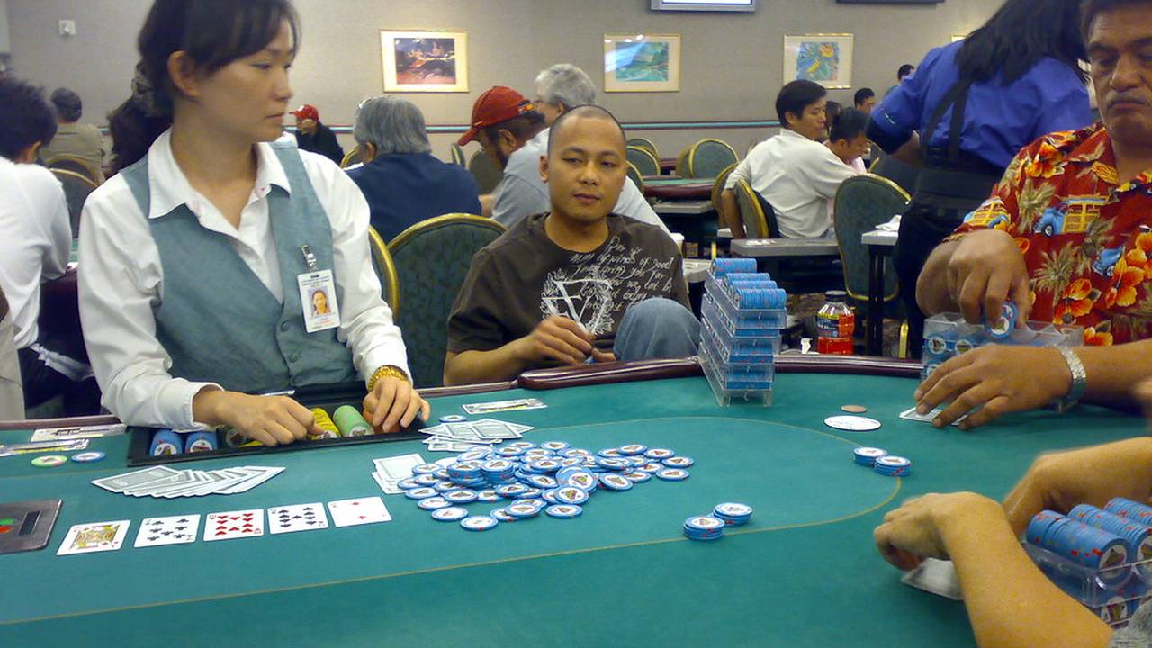 Tavolo da poker con la croupier che distribuisce le carte in una sala da gioco